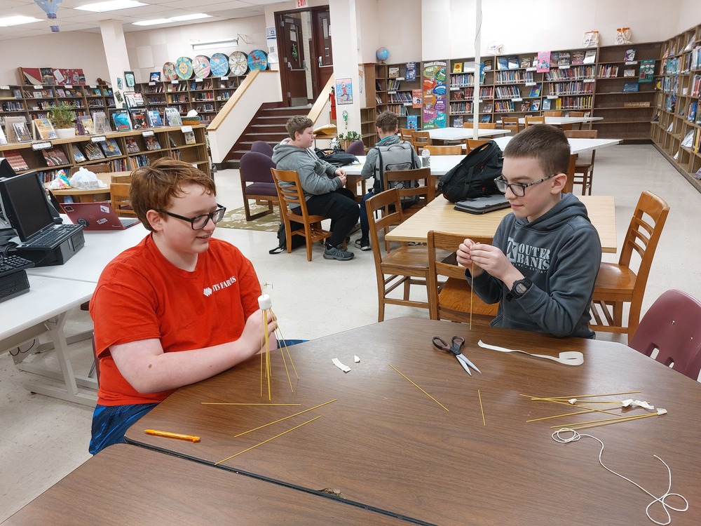 students building a tower with a marshmallow and other materials