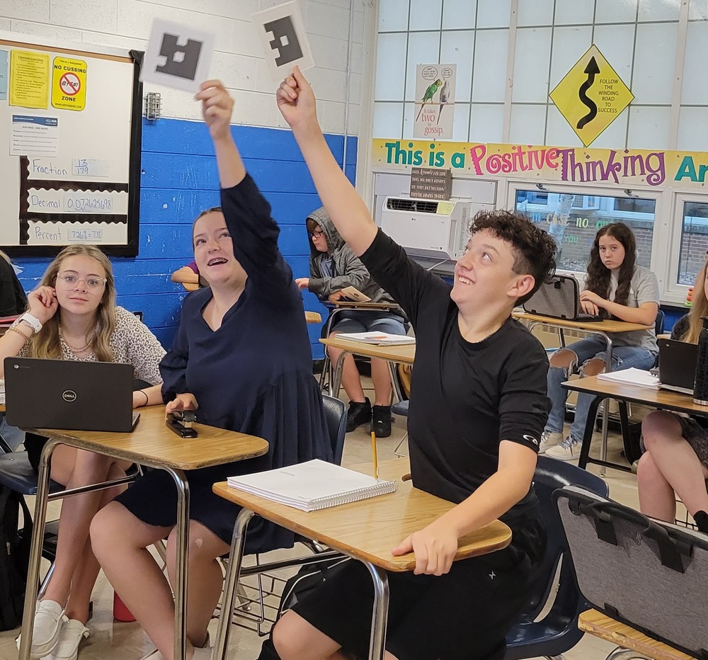 students holding up cards