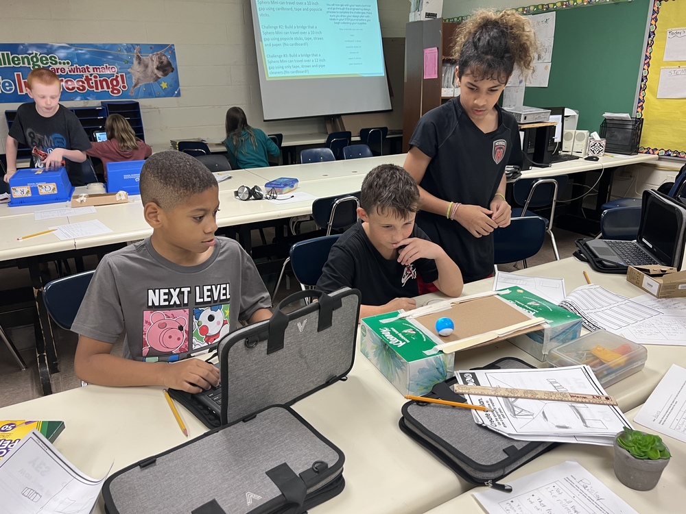 Students at LES learning to code robots 