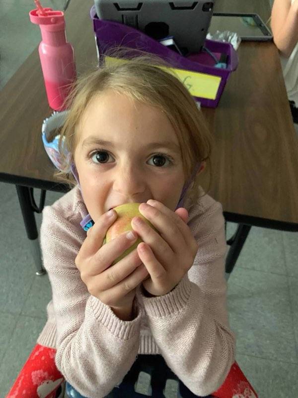 Student crunching an apple