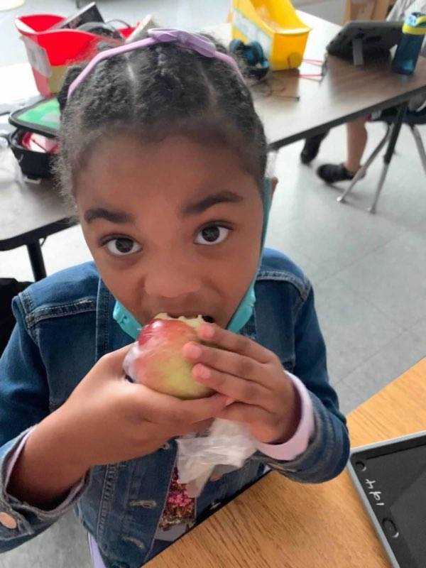 Student crunching an apple