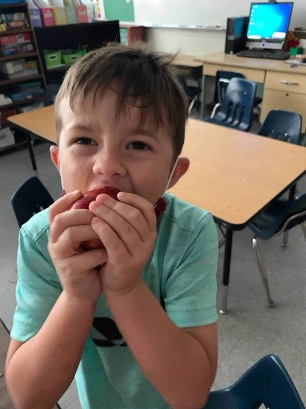 Student crunching an apple