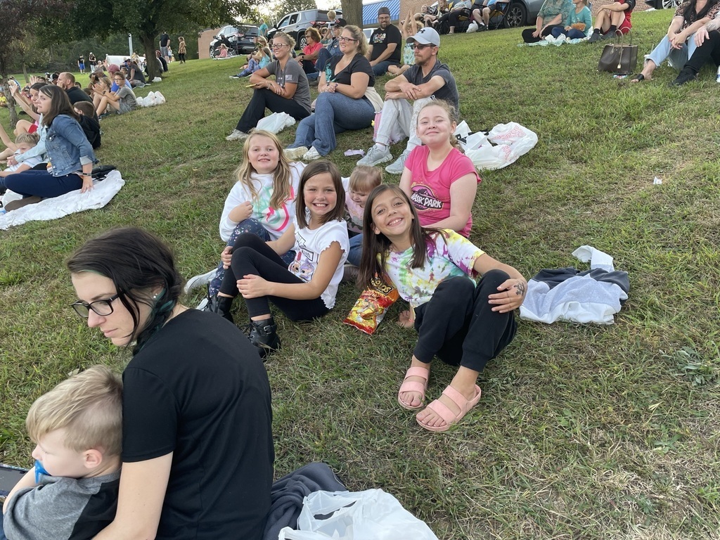 crowd sitting on the grass
