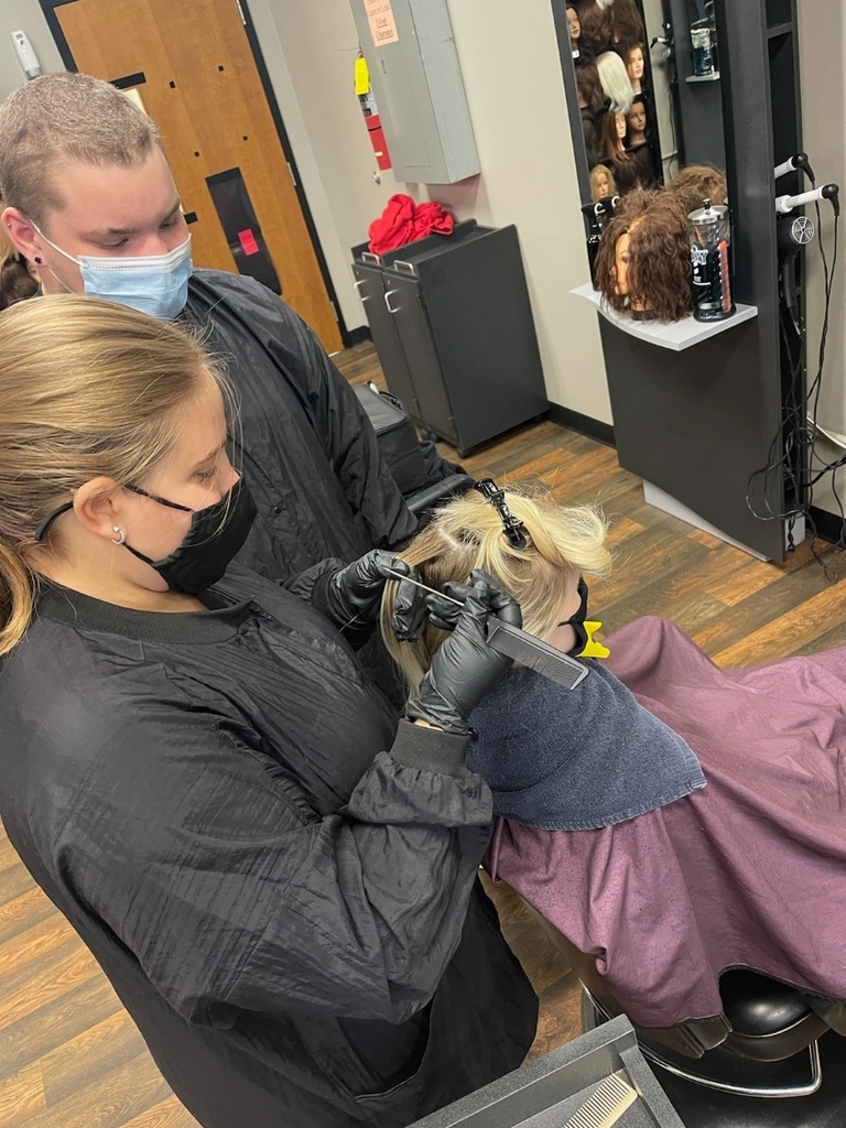 cosmetology students working on hair