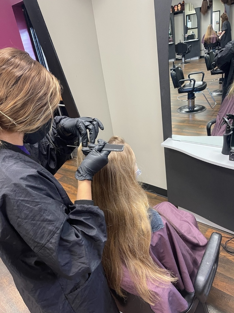 cosmetology students working on hair