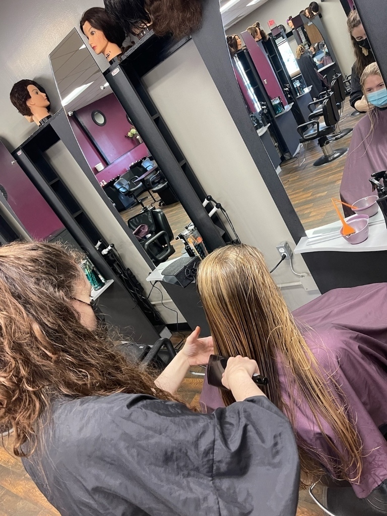 cosmetology students working on hair
