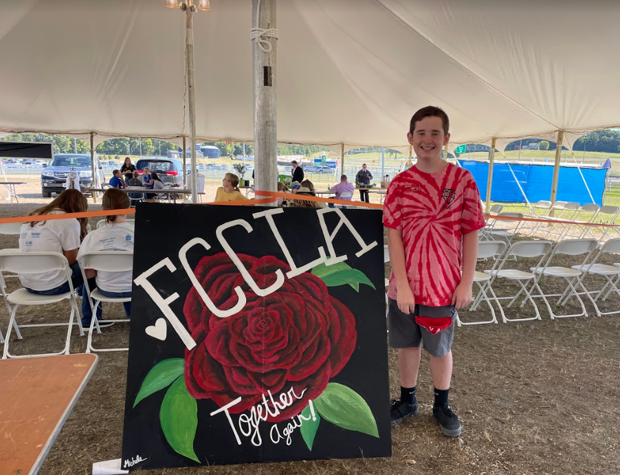 student next to sign saying FCCLA together again!