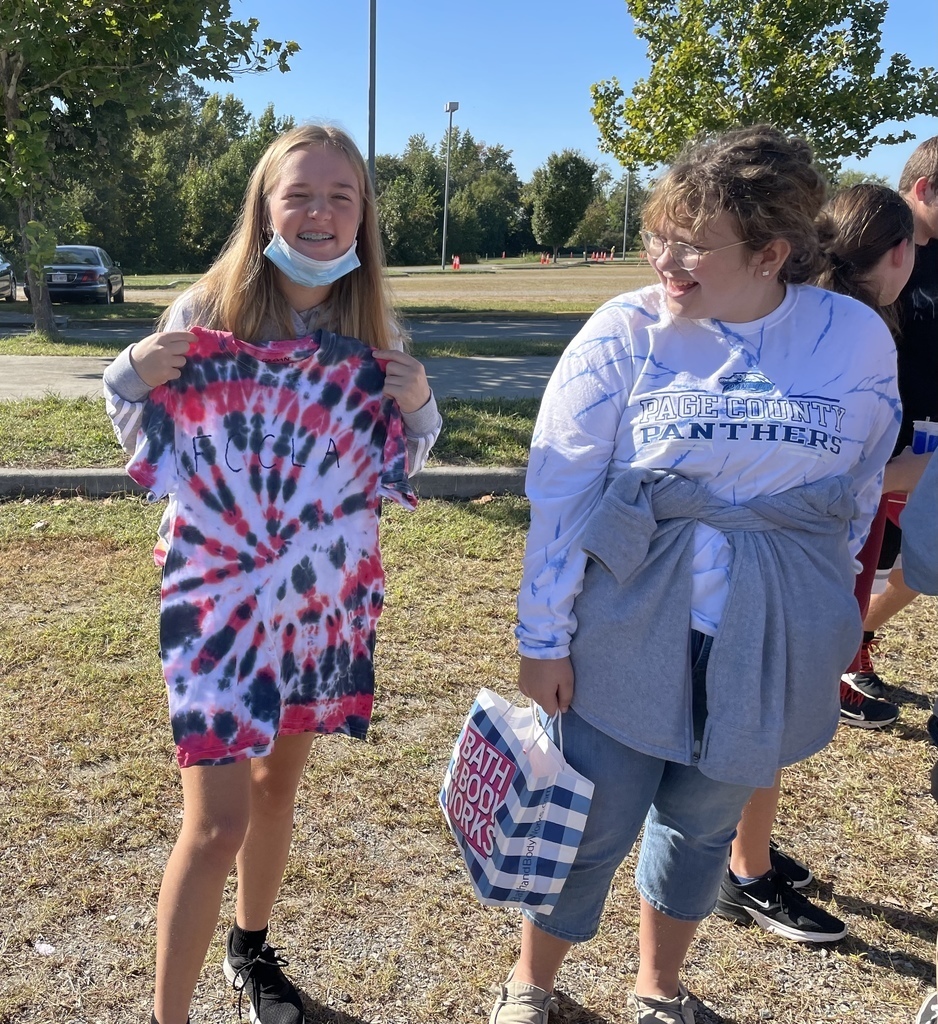 student and adult showing off shirt of fccla